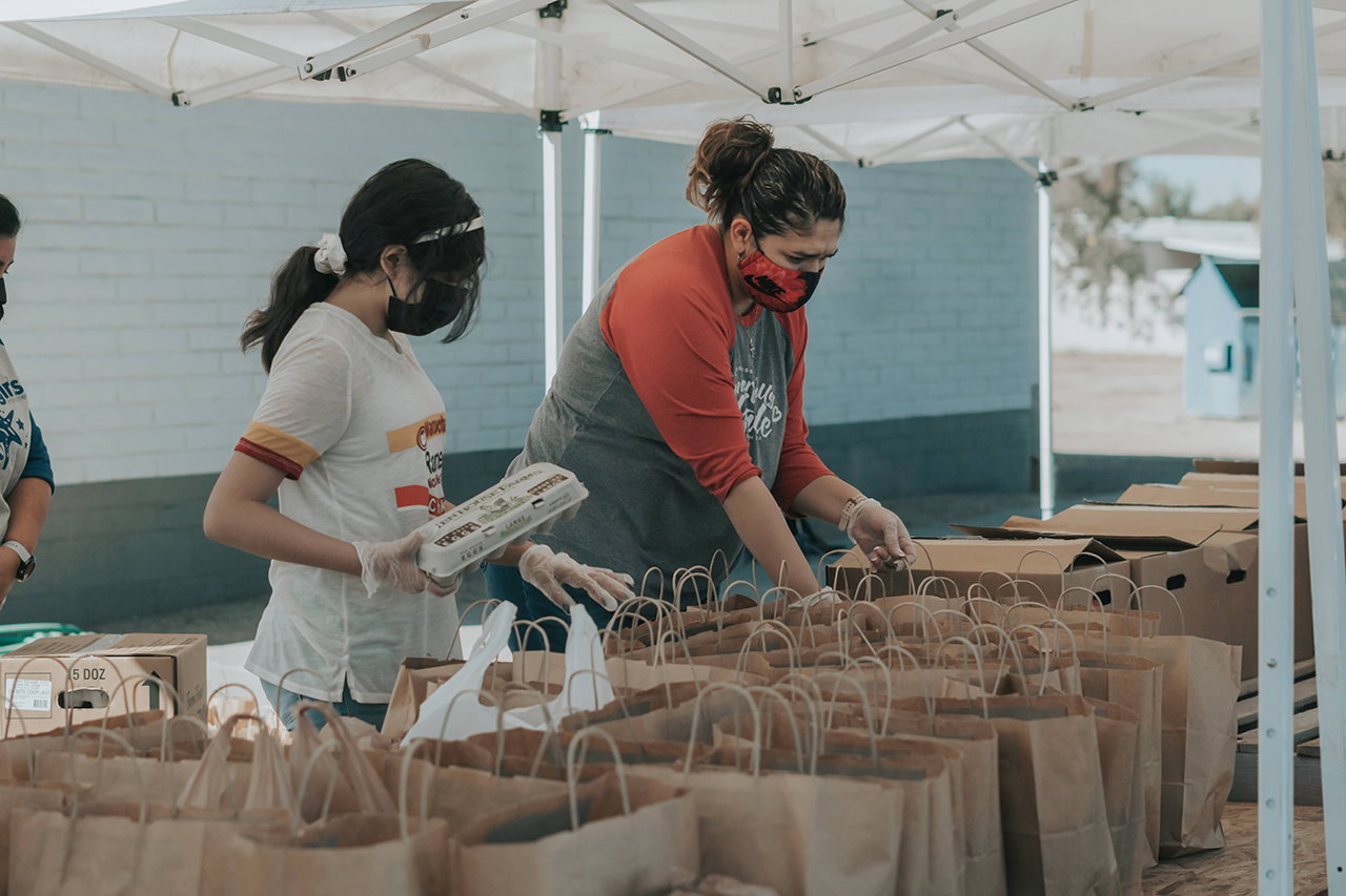 woman and child organizing items in bags