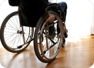 Person in a wheel chair looking out the window