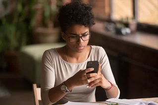 Woman looking concerned at phone