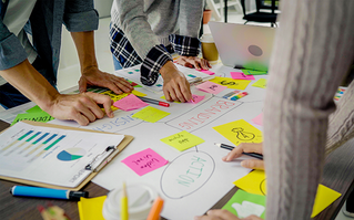 people working on a strategy with poster and notes